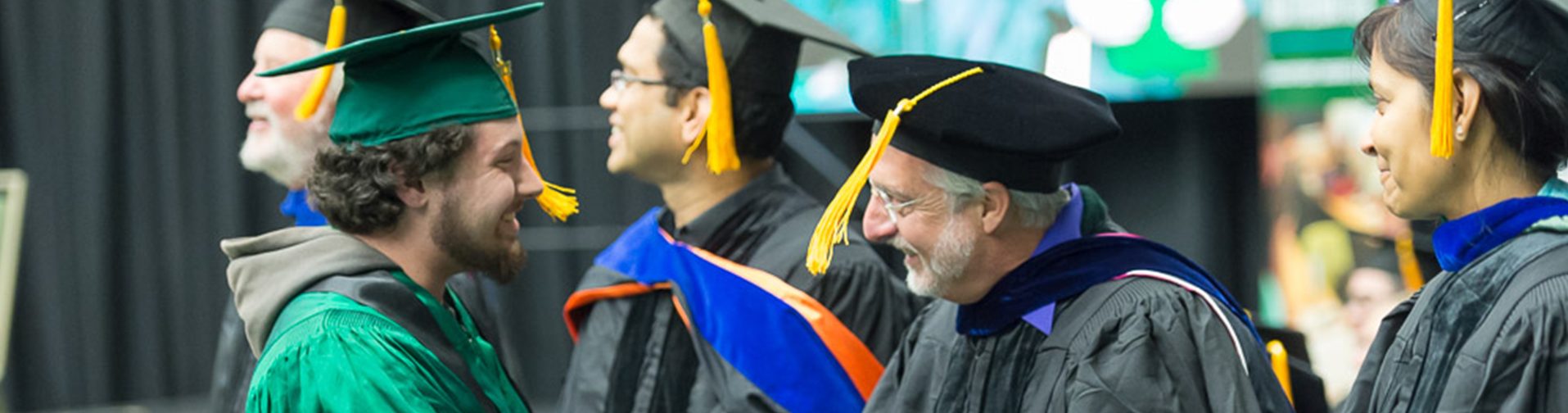 Computer science student and four faculty at commencement ceremony