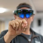 photo of man wearing virtual reality equipment