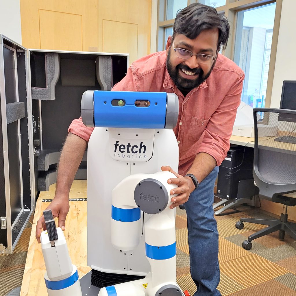 Assistant Professor Sarath Sreedharan and robot Shakey Jr.